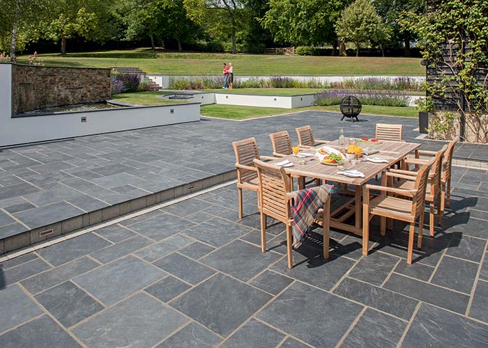 Photo of a large patio with natural slate paving