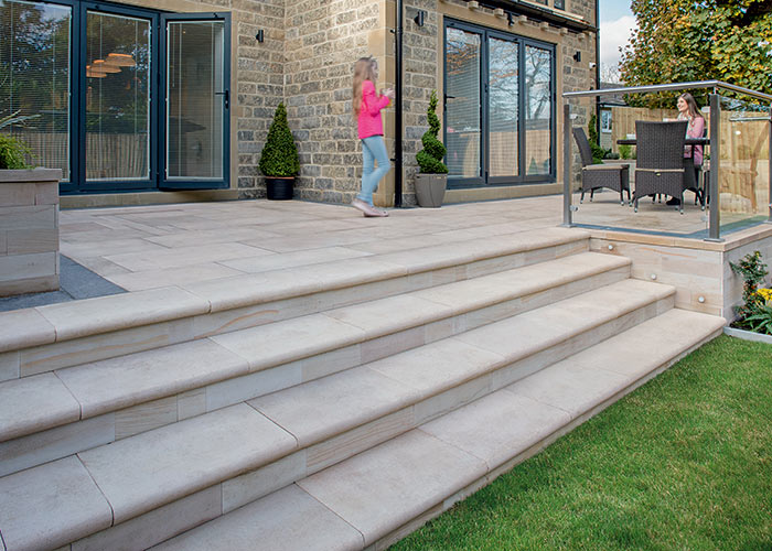 Photo of a stylish patio with steps down to lawn area